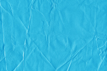 Blue vintage and old looking crumpled paper background. Retro cardboard texture. Grunge paper for drawing. Ancient book page. Present wrapping.