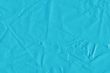 Blue vintage and old looking crumpled paper background. Retro cardboard texture. Grunge paper for drawing. Ancient book page. Present wrapping.