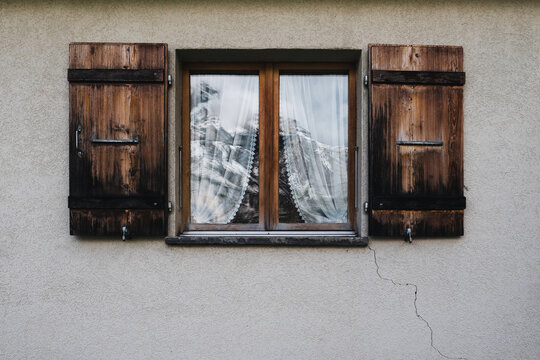 old window with mountain reflection