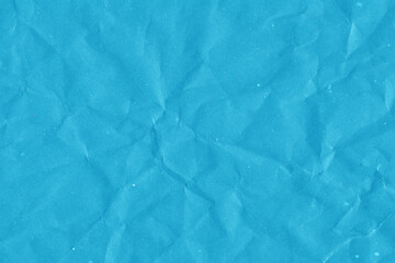 Blue vintage and old looking crumpled paper background. Retro cardboard texture. Grunge paper for drawing. Ancient book page. Present wrapping.