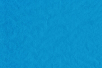 Blue vintage and old looking crumpled paper background. Retro cardboard texture. Grunge paper for drawing. Ancient book page. Present wrapping.