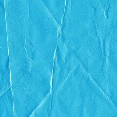 Blue vintage and old looking crumpled paper background. Retro cardboard texture. Grunge paper for drawing. Ancient book page. Present wrapping.