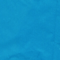 Blue vintage and old looking crumpled paper background. Retro cardboard texture. Grunge paper for drawing. Ancient book page. Present wrapping.