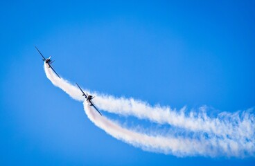 two jets with contrails in airshow - obrazy, fototapety, plakaty