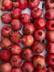 Ripe juicy pomegranates on the market macro