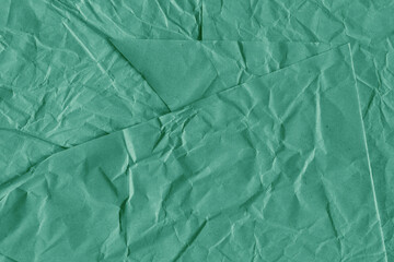 Blue vintage and old looking crumpled paper background. Retro cardboard texture. Grunge paper for drawing. Ancient book page. Present wrapping.