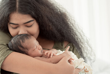 African mom kissing her baby