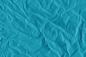 Blue vintage and old looking crumpled paper background. Retro cardboard texture. Grunge paper for drawing. Ancient book page. Present wrapping.