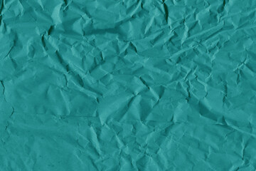 Blue vintage and old looking crumpled paper background. Retro cardboard texture. Grunge paper for drawing. Ancient book page. Present wrapping.