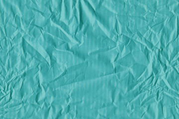 Blue vintage and old looking crumpled paper background. Retro cardboard texture. Grunge paper for drawing. Ancient book page. Present wrapping.