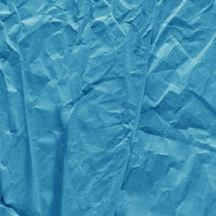 Blue vintage and old looking crumpled paper background. Retro cardboard texture. Grunge paper for drawing. Ancient book page. Present wrapping.