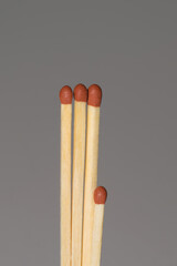 Four matches on a grey background. One match is shorter.