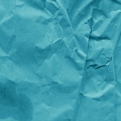 Blue vintage and old looking crumpled paper background. Retro cardboard texture. Grunge paper for drawing. Ancient book page. Present wrapping.