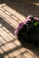 Beautiful bouquet of pink flowers on the wooden floor