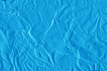 Blue vintage and old looking crumpled paper background. Retro cardboard texture. Grunge paper for drawing. Ancient book page. Present wrapping.