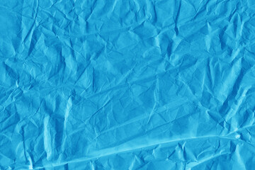Obraz premium Blue vintage and old looking crumpled paper background. Retro cardboard texture. Grunge paper for drawing. Ancient book page. Present wrapping.