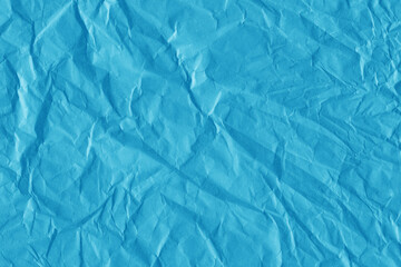 Blue vintage and old looking crumpled paper background. Retro cardboard texture. Grunge paper for drawing. Ancient book page. Present wrapping.