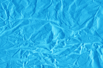 Blue vintage and old looking crumpled paper background. Retro cardboard texture. Grunge paper for drawing. Ancient book page. Present wrapping.