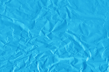 Blue vintage and old looking crumpled paper background. Retro cardboard texture. Grunge paper for drawing. Ancient book page. Present wrapping.