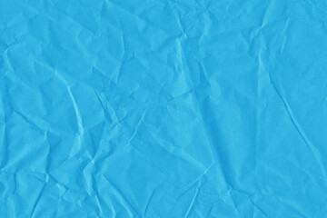 Blue vintage and old looking crumpled paper background. Retro cardboard texture. Grunge paper for drawing. Ancient book page. Present wrapping.