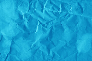 Blue vintage and old looking crumpled paper background. Retro cardboard texture. Grunge paper for drawing. Ancient book page. Present wrapping.