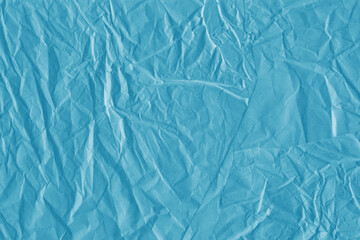 Blue vintage and old looking crumpled paper background. Retro cardboard texture. Grunge paper for drawing. Ancient book page. Present wrapping.