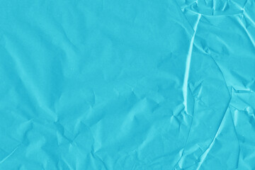 Blue vintage and old looking crumpled paper background. Retro cardboard texture. Grunge paper for drawing. Ancient book page. Present wrapping.