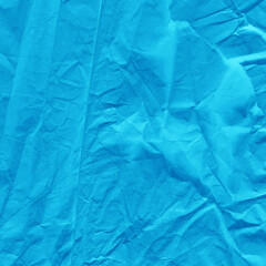 Blue vintage and old looking crumpled paper background. Retro cardboard texture. Grunge paper for drawing. Ancient book page. Present wrapping.