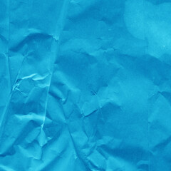 Obraz premium Blue vintage and old looking crumpled paper background. Retro cardboard texture. Grunge paper for drawing. Ancient book page. Present wrapping.