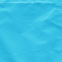 Blue vintage and old looking crumpled paper background. Retro cardboard texture. Grunge paper for drawing. Ancient book page. Present wrapping.