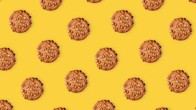 seamless looping pattern animation of peanut cookies on a yellow background