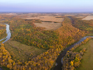 Aerial View of Winding River with Autumn Trees and Farm Fields in Rural North Dakota.