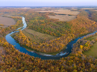 Aerial View of Winding River with Autumn Trees and Farm Fields in Rural North Dakota.