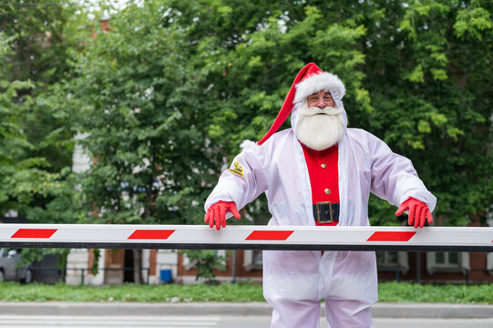 Santa Claus in a protective suit outdoors during the coronavirus epidemic