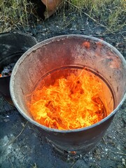 Fire in an old barrel on the street.