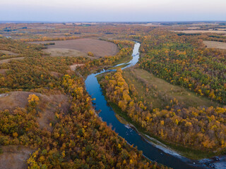 Aerial View of Winding River with Autumn Trees and Farm Fields in Rural North Dakota.