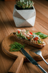 Italian tomato bruschetta with chopped vegetables, herbs and butter on toast or toasted ciabatta bread.