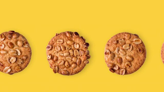 seamless looping animation of peanut cookies. one row of different homemade pastries on a yellow background