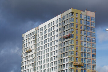 Fototapeta premium Construction of modern multi-storey buildings. New development of a residential area. House frames and exterior work on the construction site.