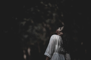 Portrait of asian woman make up ghost face with blood,Horror scene,Scary background,Halloween...