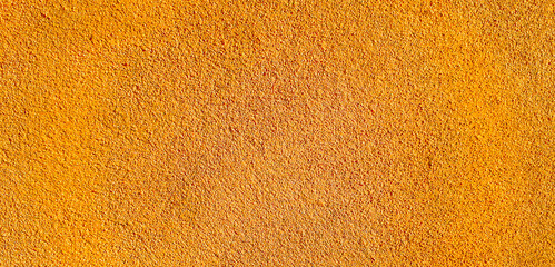 Background.  Plaster on the wall, bathed in sunset light.  Orange color.