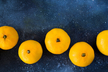 large group of the clementines on the blue background