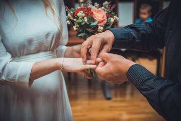 n unrecognizable bride and groom exchanging of the Wedding Rings in wedding ceremony