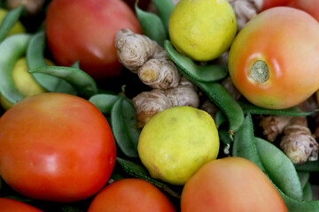 portrait view of mix vegetable tomato, ginger, lime and green peas