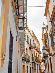 Fototapeta na wymiar very narrow traditional spanish street. Sevilla, Andalusia. Spain