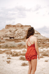 Young woman on a red dress on the Barcenas Reales desert