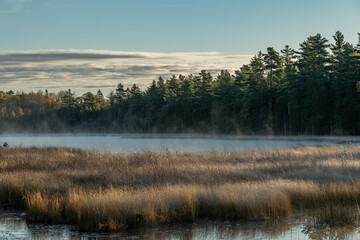 Fototapeta na wymiar Mist over the lake at Sunrise Landscape