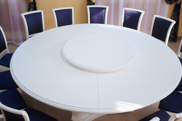 Empty white round conference table and chairs. Diplomatic background.