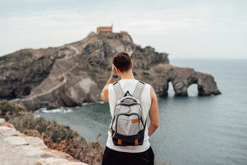 Young man in front of the Gaztelugatxe Island