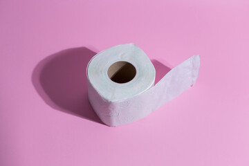 Toilete paper on a pink background. Minimal concept.